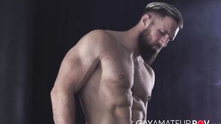 Hairy hunk Chuck Conrad works his massive dick with his two hands after flexing his t
