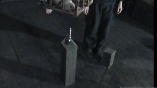 Caged sub anally impaled