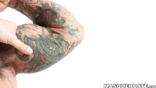 Inked hunk is masturbating for the camera before cumming
