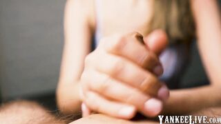 Red-lipped beauty gives an intense handjob to her man