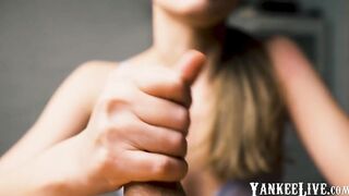 Red-lipped beauty gives an intense handjob to her man