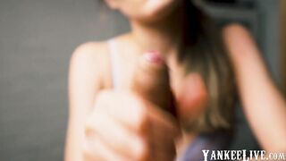 Red-lipped beauty gives an intense handjob to her man