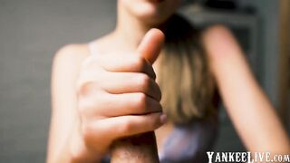 Red-lipped beauty gives an intense handjob to her man