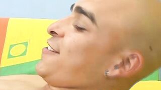 Kinky skinhead latino Cristobal is on the sofa wanking dick