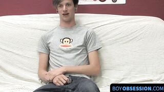 On a couch by himself cute gay man Danny jerks off his dick