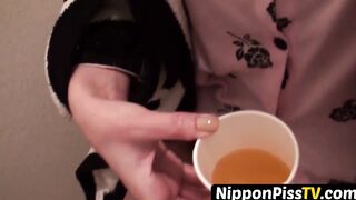 Japanese dollface tops a cup off with her pee and records it