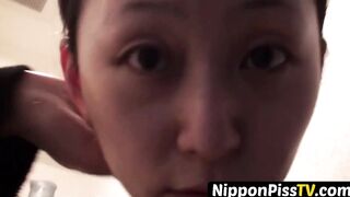 Japanese dollface tops a cup off with her pee and records it