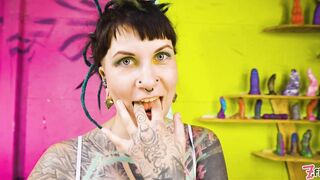 Tattooed model Illuz tests out her toys