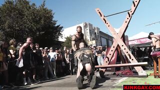 A crowd gathers to watch the brutal flogging