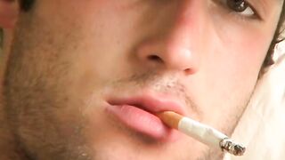 Hottie Cody lights his red cig while stroking his pinkish cock
