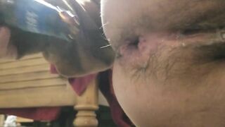 Unshaved cunt takes bottle inside booty