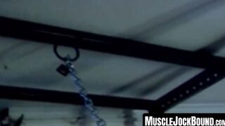 MuscleJockBound.com - Muscular man silenced with a ball gag while being heavily chain