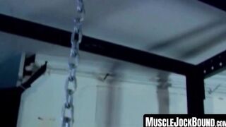 MuscleJockBound.com - Muscular man silenced with a ball gag while being heavily chain