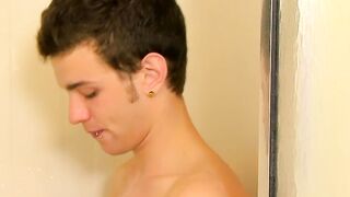 Handsome young man works on his dick under the shower