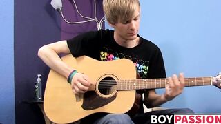 Young man plays guitar before dick stroking and cumming