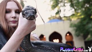 Redhead snake charmer poses nude outdoor