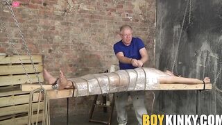 Bound young twink enjoys handjob from mature master